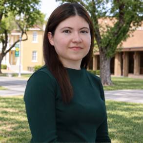 Director of Center for Academic Technology posing in front of building for a picture.