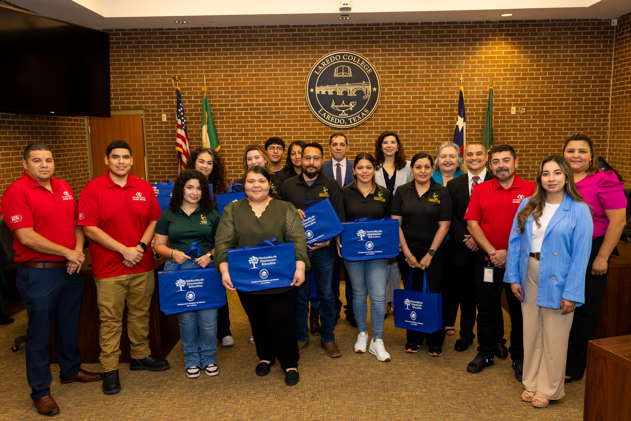 Group photo with students holding donated laptops.