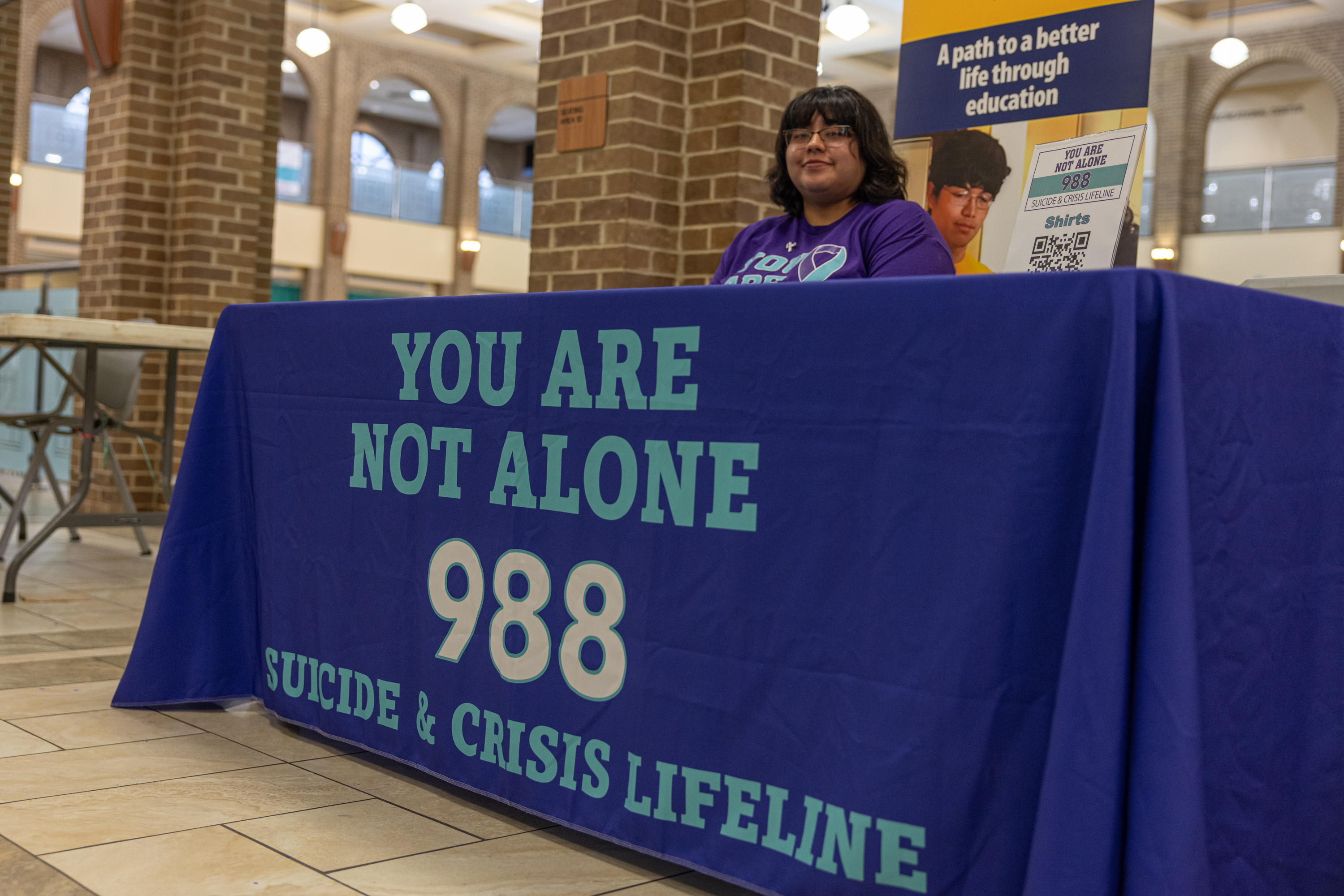 A purple banner is draped over table