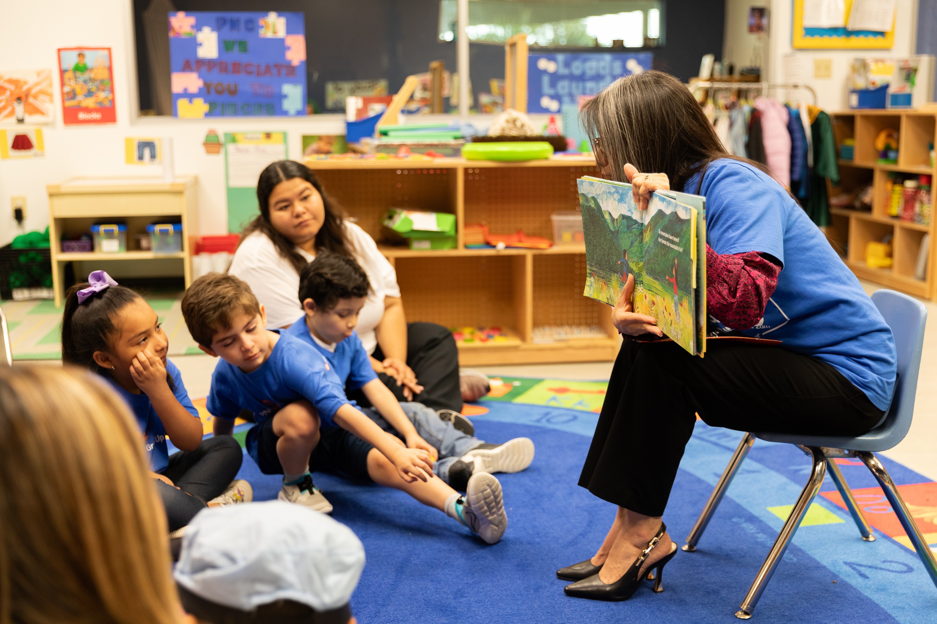 volunteer reads book to children