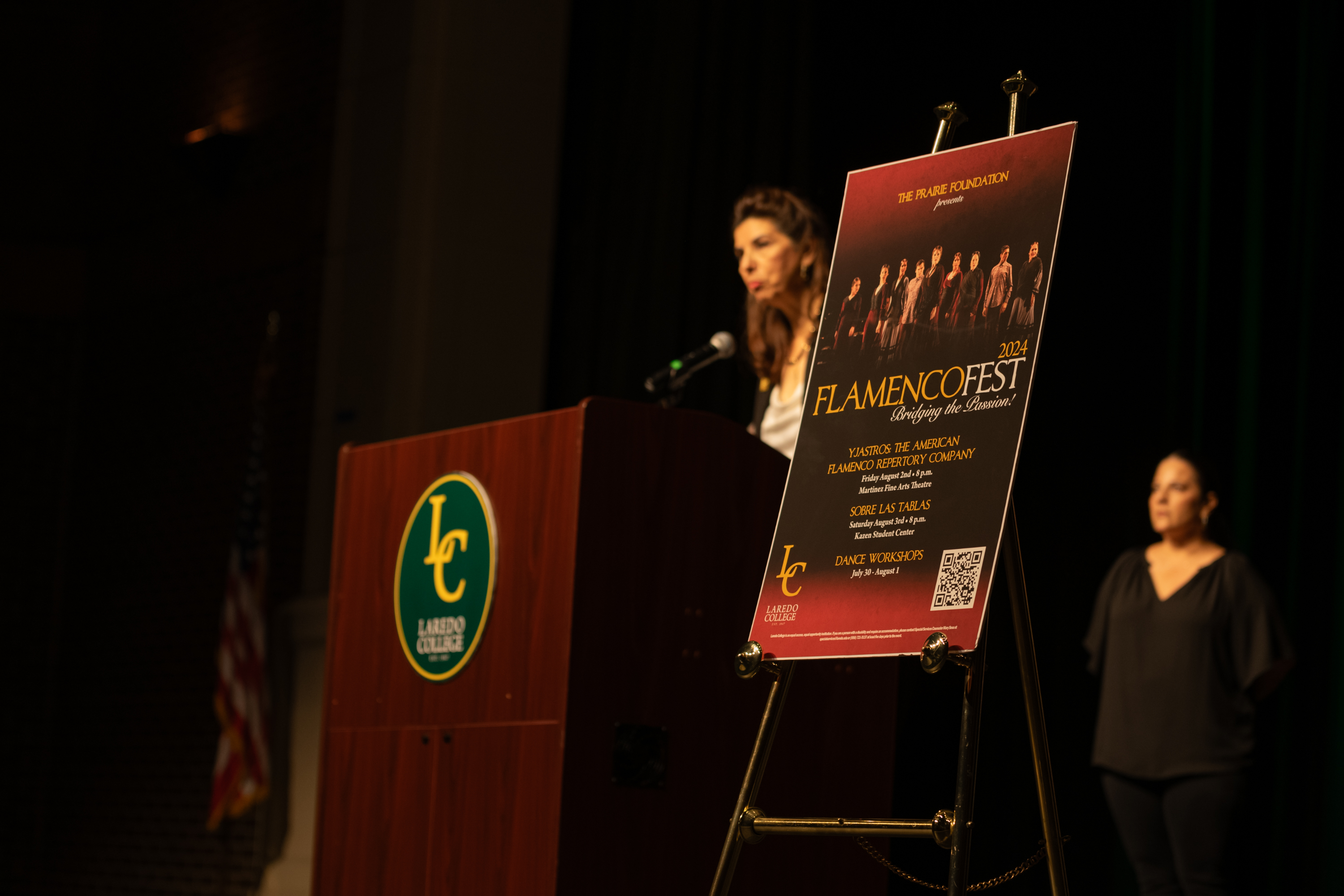 A flamencofest poster stands alongside podium