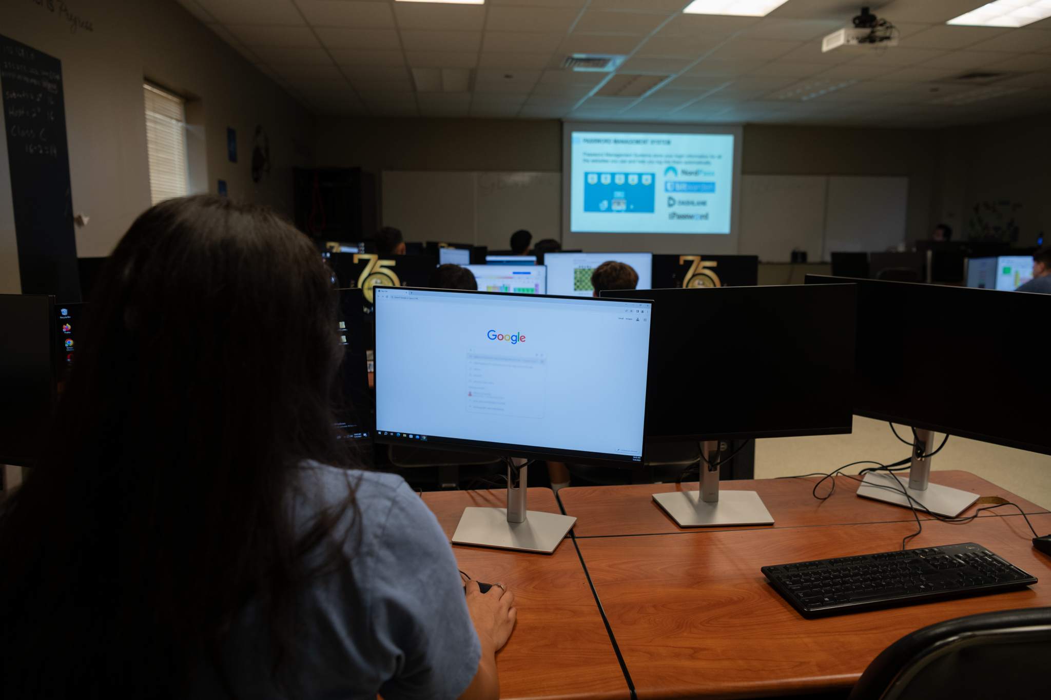 student listens to lecture in computer class